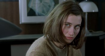 Movie still from “Read My Lips” (2001), directed by Jacques Audiard – A person wearing a sweater and looking sad; Close Up shot, High angle