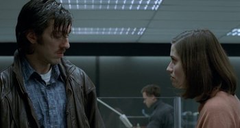 Movie still from “Read My Lips” (2001), directed by Jacques Audiard – Two people standing next to each other in a room; Close Up shot, Low angle