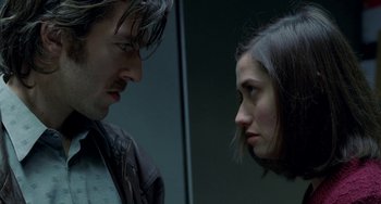 Movie still from “Read My Lips” (2001), directed by Jacques Audiard – A man and a woman face to face in front of each other; Close Up shot, Overhead angle