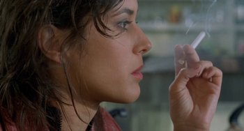 Movie still from “Read My Lips” (2001), directed by Jacques Audiard – A person holding a cell phone; Close Up shot, Over the shoulder angle