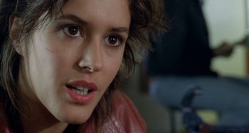Movie still from “Read My Lips” (2001), directed by Jacques Audiard – A woman's face in a leather jacket; Close Up shot, Over the shoulder angle