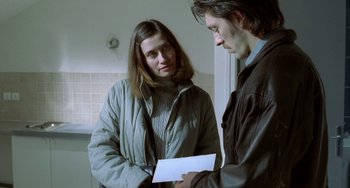 Movie still from “Read My Lips” (2001), directed by Jacques Audiard – A man and a woman looking at a piece of paper; Medium shot, Over the shoulder angle