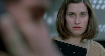 Movie still from “Read My Lips” (2001), directed by Jacques Audiard – A person with short brown hair; Close Up shot, Over the shoulder angle