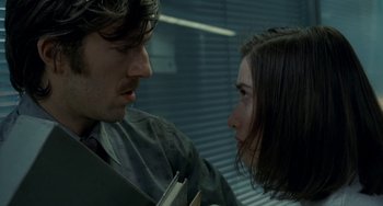 Movie still from “Read My Lips” (2001), directed by Jacques Audiard – A man and a woman looking at one another; Close Up shot, Over the shoulder angle