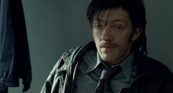 Movie still from “Read My Lips” (2001), directed by Jacques Audiard – A person wearing a suit and tie; Close Up shot, High angle