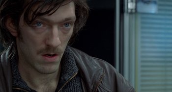 Movie still from “Read My Lips” (2001), directed by Jacques Audiard – A person wearing a leather jacket; Close Up shot, High angle