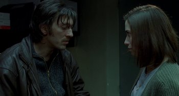 Movie still from “Read My Lips” (2001), directed by Jacques Audiard – A man and a woman standing next to each other; Close Up shot, Over the shoulder angle