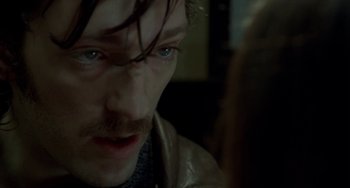 Movie still from “Read My Lips” (2001), directed by Jacques Audiard – A man's face as he stares at the camera; Close Up shot, High angle