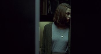 Movie still from “Read My Lips” (2001), directed by Jacques Audiard – A woman standing in front of a mirror; Medium shot, Over the shoulder angle