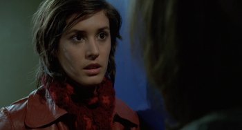 Movie still from “Read My Lips” (2001), directed by Jacques Audiard – A young woman wearing a red scarf looking at the camera; Close Up shot, Over the shoulder angle