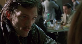 Movie still from “Read My Lips” (2001), directed by Jacques Audiard – A person wearing a leather jacket; Close Up shot, Over the shoulder angle