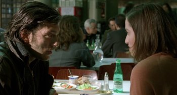 Movie still from “Read My Lips” (2001), directed by Jacques Audiard – A man and a woman sitting at a table with a plate of food; Close Up shot, Over the shoulder angle