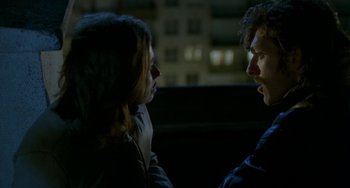 Movie still from “Read My Lips” (2001), directed by Jacques Audiard – A man and a woman talking to each other in the dark; Medium shot, Over the shoulder angle