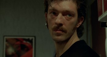 Movie still from “Read My Lips” (2001), directed by Jacques Audiard – A person with a mustache; Close Up shot, Low angle