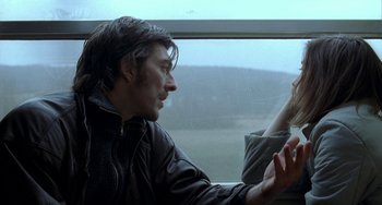 Movie still from “Read My Lips” (2001), directed by Jacques Audiard – A man and a woman looking out of a window; Close Up shot, Over the shoulder angle