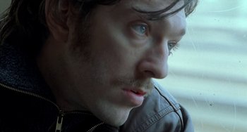 Movie still from “Read My Lips” (2001), directed by Jacques Audiard – A person wearing a jacket; Close Up shot, High angle