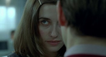Movie still from “Read My Lips” (2001), directed by Jacques Audiard – A woman's face and a man's face; Close Up shot, Over the shoulder angle