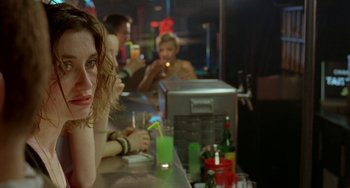 Movie still from “Read My Lips” (2001), directed by Jacques Audiard – A group of people sitting at a bar drinking; Close Up shot, Over the shoulder angle