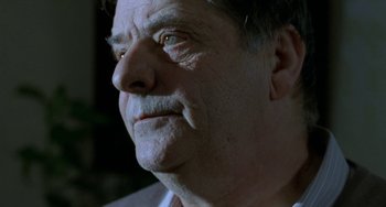Movie still from “Read My Lips” (2001), directed by Jacques Audiard – An older man looking up into the sky; Close Up shot, Low angle