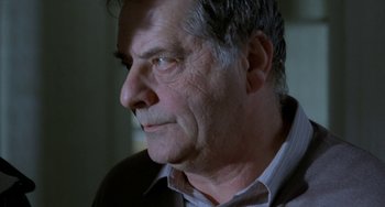 Movie still from “Read My Lips” (2001), directed by Jacques Audiard – An older man looking to his left; Close Up shot, Over the shoulder angle