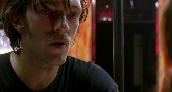 Movie still from “Read My Lips” (2001), directed by Jacques Audiard – A person with a mustache; Close Up shot, Low angle