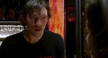 Movie still from “Read My Lips” (2001), directed by Jacques Audiard – A person wearing a black shirt; Close Up shot, Low angle