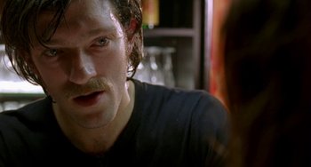 Movie still from “Read My Lips” (2001), directed by Jacques Audiard – A person with a mustache; Close Up shot, Over the shoulder angle