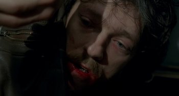 Movie still from “Read My Lips” (2001), directed by Jacques Audiard – A person with blood on his face; Close Up shot, Overhead angle
