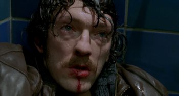 Movie still from “Read My Lips” (2001), directed by Jacques Audiard – A person with blood on his face; Close Up shot, Overhead angle
