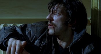 Movie still from “Read My Lips” (2001), directed by Jacques Audiard – A person with a backpack; Close Up shot, Low angle