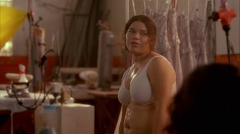 Movie still from “Real Women Have Curves” (2002), directed by Patricia Cardoso – A woman in a white bra standing in front of a mirror; Medium shot, Over the shoulder angle