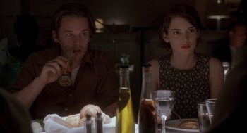 Movie still from “Reality Bites” (1994), directed by Ben Stiller – A man and a woman sitting at a dinner table; Medium shot, Over the shoulder angle