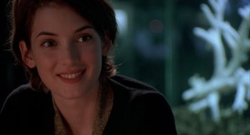 Movie still from “Reality Bites” (1994), directed by Ben Stiller – A person smiling for the camera; Close Up shot, Over the shoulder angle