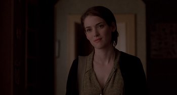 Movie still from “Reality Bites” (1994), directed by Ben Stiller – A beautiful young woman standing in a room; Close Up shot, Over the shoulder angle