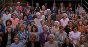 Movie still from “Reality Bites” (1994), directed by Ben Stiller – A large group of older women sitting in front of a window; Wide shot, High angle
