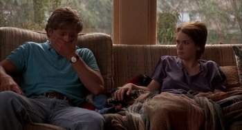 Movie still from “Reality Bites” (1994), directed by Ben Stiller – Two women sitting on a couch in front of a window; Medium shot, Over the shoulder angle