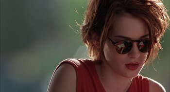 Movie still from “Reality Bites” (1994), directed by Ben Stiller – A person wearing a red shirt and sunglasses; Close Up shot, Over the shoulder angle