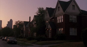 Movie still from “Reality Bites” (1994), directed by Ben Stiller – A row of houses on a street at night; Extreme Wide shot, Low angle