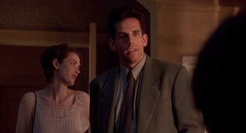 Movie still from “Reality Bites” (1994), directed by Ben Stiller – A man and a woman standing next to each other in a room; Medium shot, Low angle
