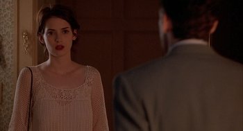 Movie still from “Reality Bites” (1994), directed by Ben Stiller – A woman standing in front of a man in front of a mirror; Medium shot, Over the shoulder angle