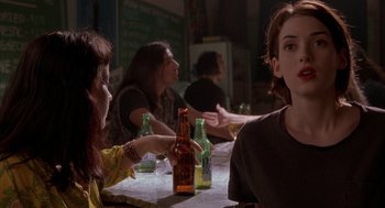 Movie still from “Reality Bites” (1994), directed by Ben Stiller – A group of people sitting at a table drinking beer; Medium shot, Over the shoulder angle