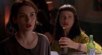 Movie still from “Reality Bites” (1994), directed by Ben Stiller – Two women sitting at a table with a bottle of beer; Close Up shot, Over the shoulder angle