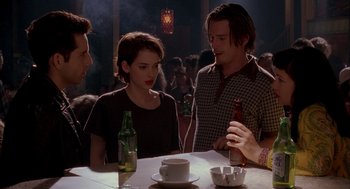 Movie still from “Reality Bites” (1994), directed by Ben Stiller – A group of people sitting at a table with drinks; Medium shot, High angle