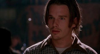 Movie still from “Reality Bites” (1994), directed by Ben Stiller – A person with long hair; Close Up shot, Over the shoulder angle