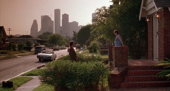 Movie still from “Reality Bites” (1994), directed by Ben Stiller – Two people standing on the side of the road; Extreme Wide shot, Over the shoulder angle