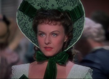 Movie still from “Reap the Wild Wind” (1942), directed by Cecil B. DeMille – A person wearing a hat and a dress; Close Up shot, Over the shoulder angle