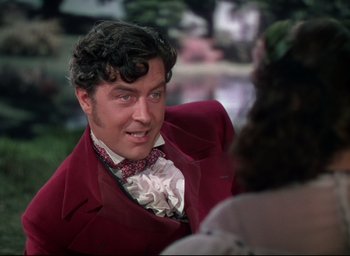 Movie still from “Reap the Wild Wind” (1942), directed by Cecil B. DeMille – A person wearing a suit and a bow tie; Close Up shot, Over the shoulder angle