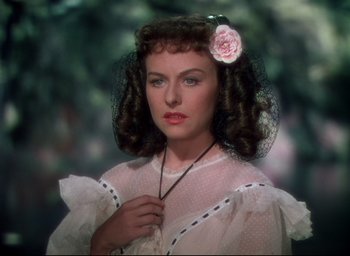 Movie still from “Reap the Wild Wind” (1942), directed by Cecil B. DeMille – A woman with a flower in her hair; Close Up shot, Over the shoulder angle