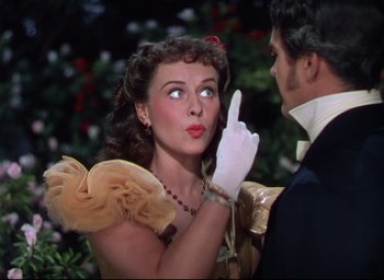 Movie still from “Reap the Wild Wind” (1942), directed by Cecil B. DeMille – A man and a woman in formal wear looking at each other; Close Up shot, Over the shoulder angle