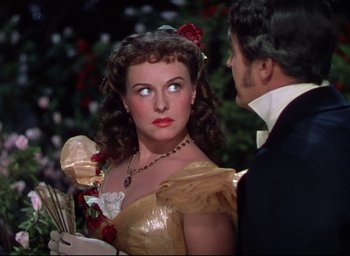 Movie still from “Reap the Wild Wind” (1942), directed by Cecil B. DeMille – A man and a woman standing next to each other in front of a christmas tree; Close Up shot, Over the shoulder angle